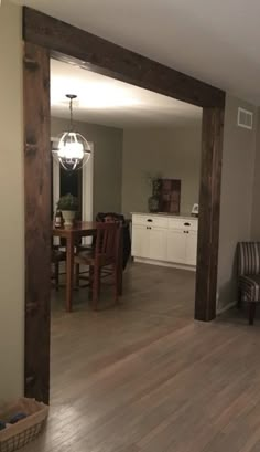 an empty living room with hard wood floors