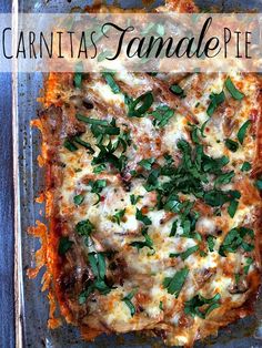 a casserole dish with cheese, meat and herbs in it on a blue plate