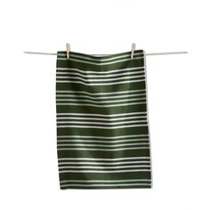 a green and white striped towel hanging on a clothes line