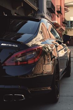 a black car parked in front of a building