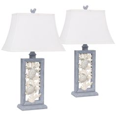 two lamps with shells on them sitting side by side, one is white and the other is blue