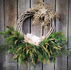 a christmas wreath hanging on the side of a wooden wall with an ornament