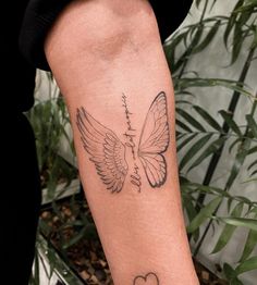 a woman's arm with a tattoo on it and a heart in the middle