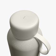 a close up of a white bottle with a strap around it's neck on a white background