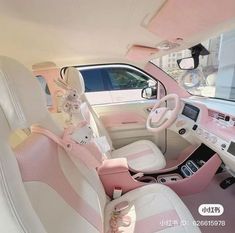 the interior of a pink and white car with stuffed animals on the steering wheel seat