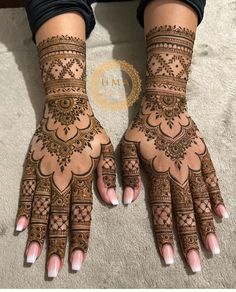 the hands and feet of a woman with henna tattoos