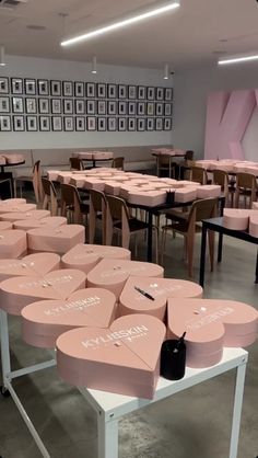 the tables and chairs are covered in pink boxes with white writing on them that spell out love