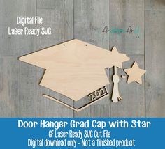 the door hanger grad cap with star cut out is shown on a wood background