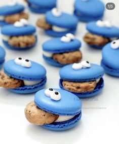 blue macaroons with googly eyes are arranged in the shape of an elephant