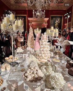 a table filled with lots of cakes and cupcakes