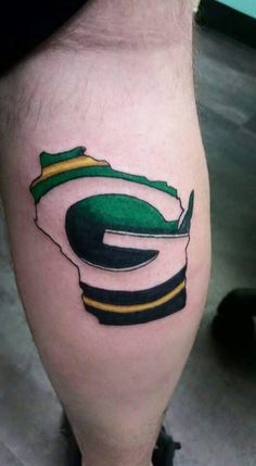 a man's leg with a green bay packers logo on it