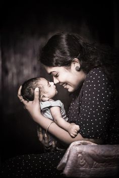 a woman holding a baby in her arms