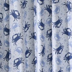 a blue and white shower curtain with crabs on it