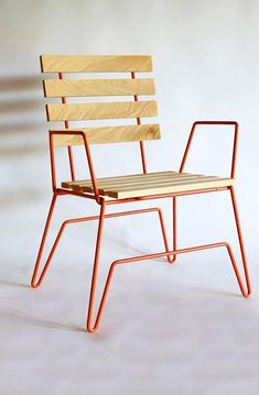 an orange chair sitting on top of a white floor next to a wooden seat with slatted back