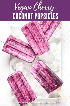 three popsicles on top of ice with the text vegan cherry coconut popsicles