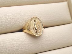 women's Virgin Mary Miraculous Medal ring made in 14k, 18k solid gold the Miraculous Medal is devotional medal, the original design was executed by Adrien Vachette based on Saint Catherine Laboure visions. the Miraculous medal with exquisite details is on the top of this ring. medal height 15.7mm, width 11.5mm (on 6.5 US) * the larger ring size, the bigger medal size is. 14k gold womens ring weight (edited on May 18 2021) 5.0 US 2.72g (±5%) 5.5 - 6.0 US 3.06g (±5%) 6.5 US 3.40g (±5%) 7.0 - 7.5 U Virgin Mary Ring, Catherine Laboure, Gold Ring Women, Saint Catherine, Tiny Rings, Womens Ring, Piercing Ring, Blessed Virgin, Blessed Virgin Mary