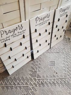 three wooden peg boards with black pins on them and the words prayers written on them