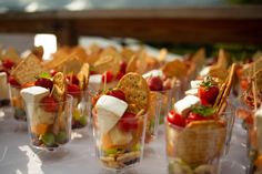 a display case filled with lots of different types of desserts on top of white plates