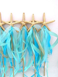 three starfish picks with blue and green streamers