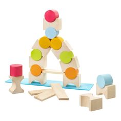 a wooden toy with different shapes and colors on the front, including blocks and circles