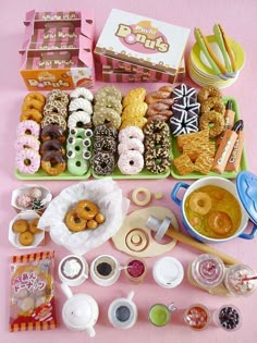 a table filled with lots of different types of donuts and desserts on it