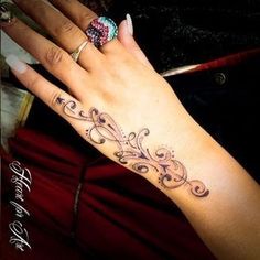 a woman's hand with a tattoo on it