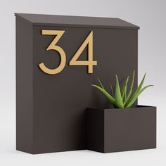 a black box with a plant in it and the number 34 written on its side