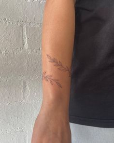 a woman's arm with a small tattoo on the left side of her arm