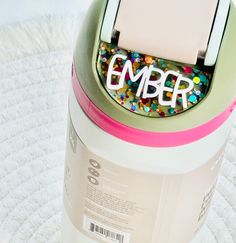 a canister with the word ember written on it and sprinkles