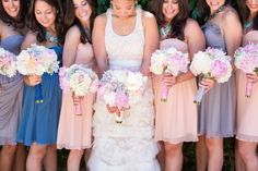 a group of women standing next to each other holding bouquets