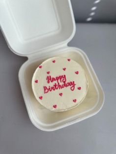 a birthday cake in a foam container with the words happy birthday written on it's side