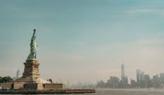 the statue of liberty is in new york city's lower east side as seen from across the water