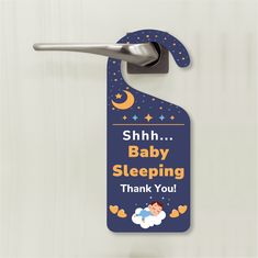 a blue door hanger with a baby sleeping thank you sign on it and a spoon hanging from the handle