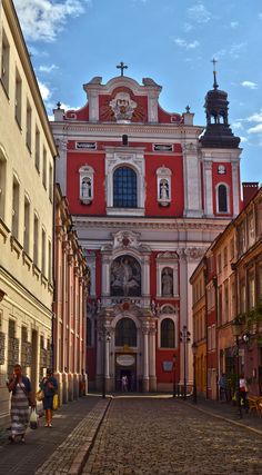 a red and white building with people walking around it