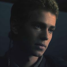 a young man is staring into the distance with an intense look on his face and shoulders