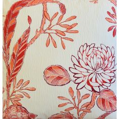 an orange and white pillow with flowers on it