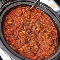 a crock pot filled with chili and corn