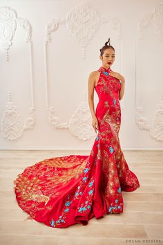 a woman in a red and gold dress posing for the camera with her hands on her hips