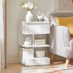 a living room with white furniture and flowers on the side table next to a chair