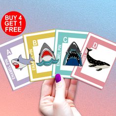 someone holding four cards with different types of sharks