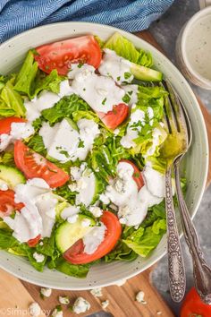 a salad with tomatoes, cucumbers and lettuce