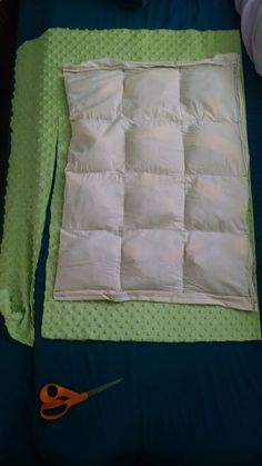 a quilted piece of cloth with scissors on it