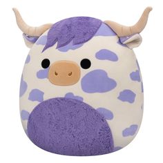 a purple and white cow stuffed animal with horns on it's head, sitting in front of a white background