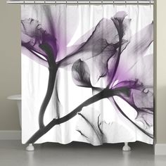 a shower curtain with purple flowers on the side and black petals on the inside, in front of a white bath tub