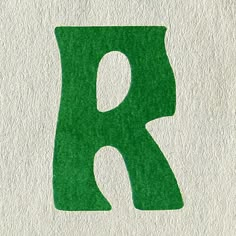 the letter k is made up of green felt