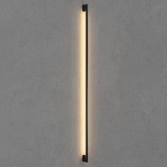 a wall mounted light that is on the side of a concrete wall with a white background