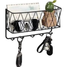 a black wire basket with sunglasses and keys hanging from the side on a white background