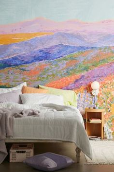 a bedroom with a large painting on the wall