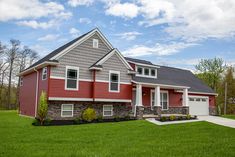 a red and gray house with two garages