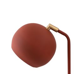 a red lamp with a gold handle on it's arm and a white background